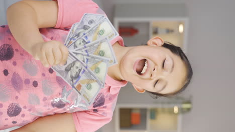 Vertical-video-of-The-girl-child-loves-money.